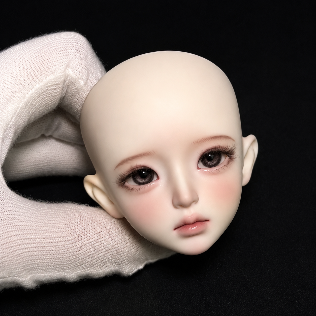 1/4 BJD doll head front view with finished face-up makeup, detailed resin sculpt and realistic doll eyes