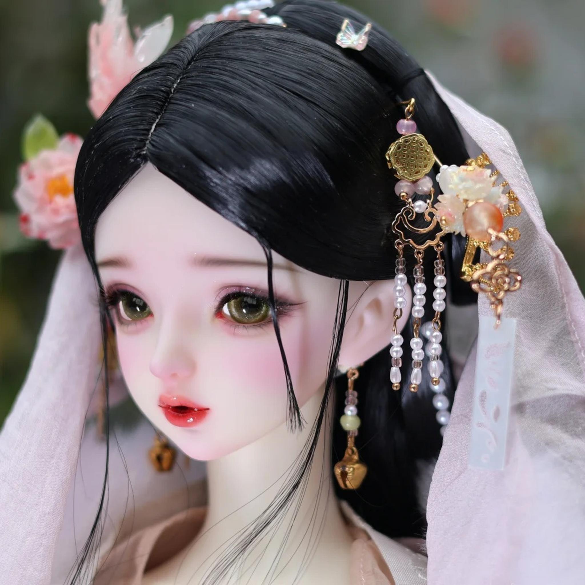 BJD head styling example with black wig, green eyes and floral hair ornaments