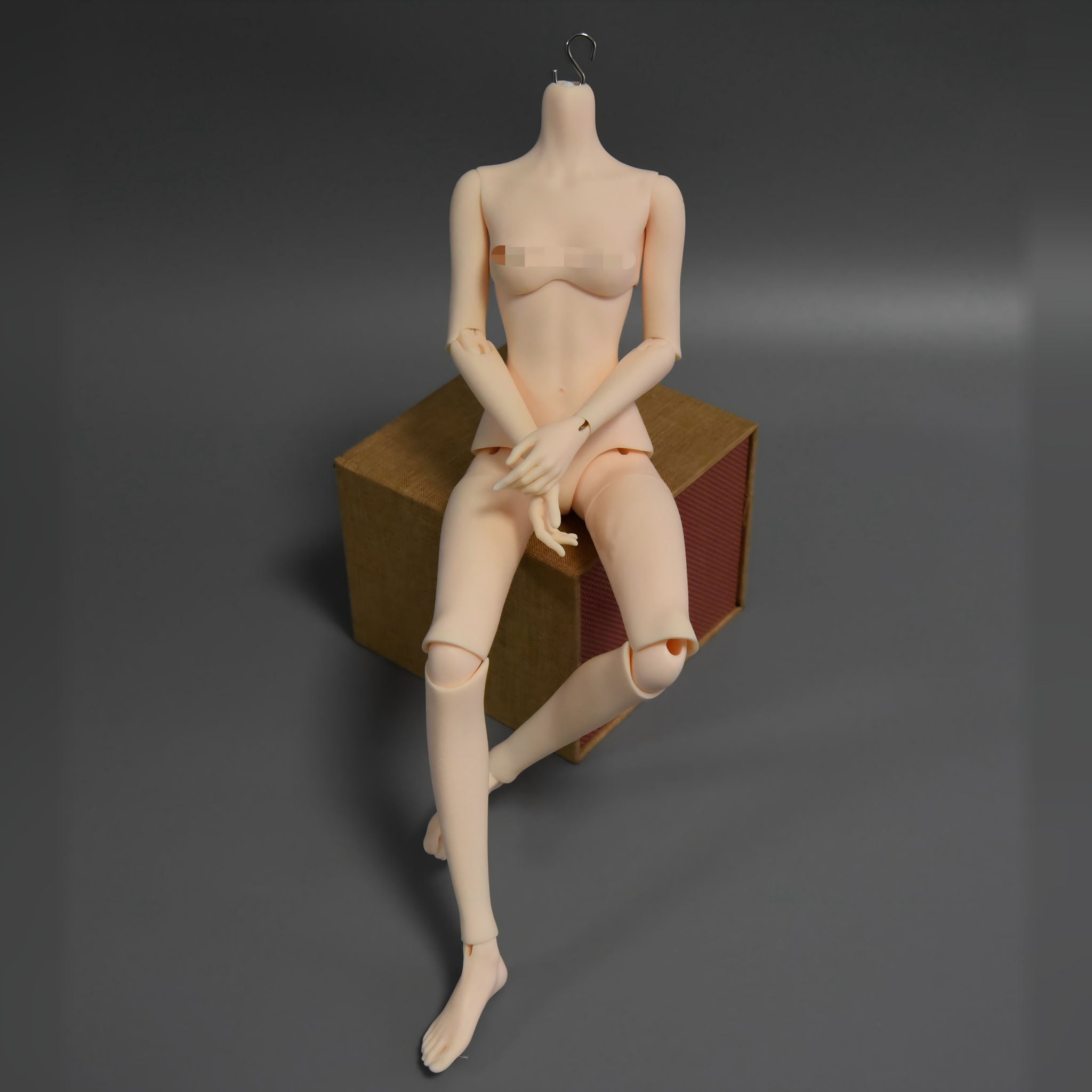 BJD doll sitting pose showing realistic body proportions and outfit details