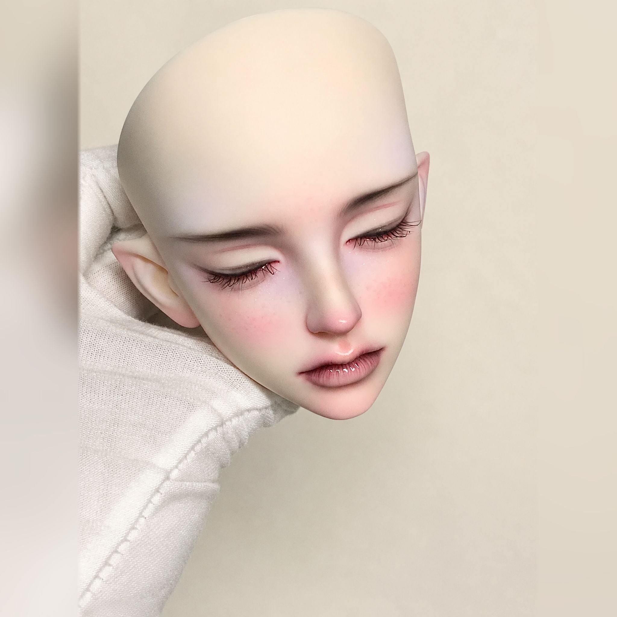 1/3 scale unisex BJD head sculpt with custom makeup, side profile view and detailed resin doll face-up showcase
