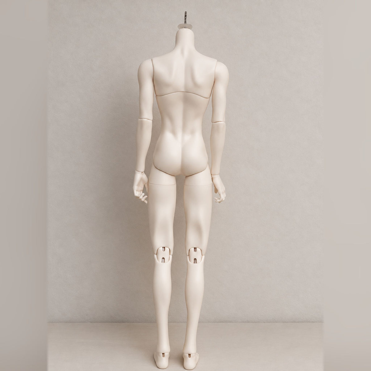 Back view of a male BJD body showing sculpted contours and articulated knee joints