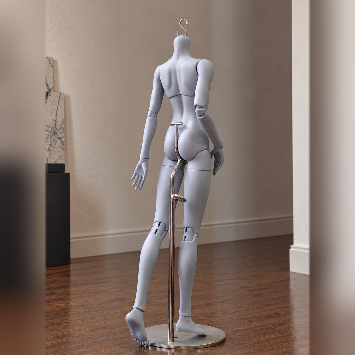 Back view of a slim male resin BJD body with articulated elbows and knees