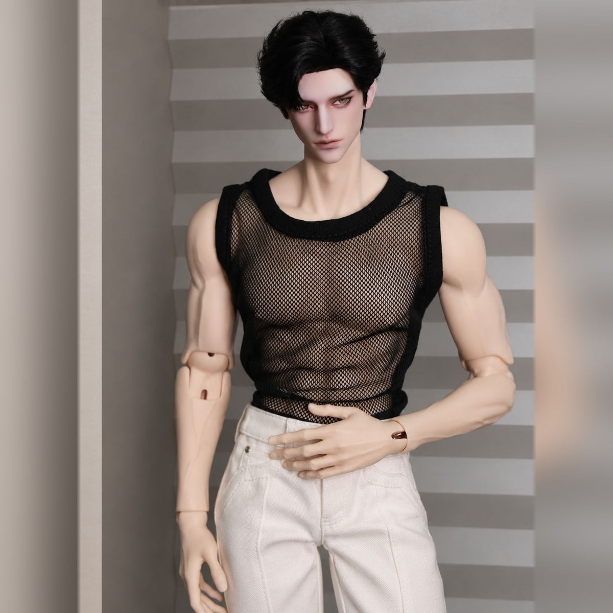 Muscular male BJD display showing broad shoulders and articulated arms