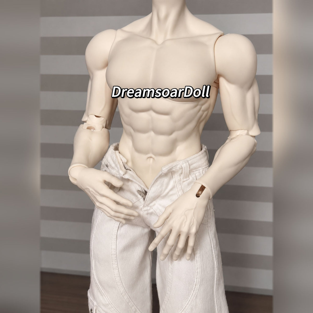 Close-up of a muscular male BJD torso with detailed abs and poseable hands