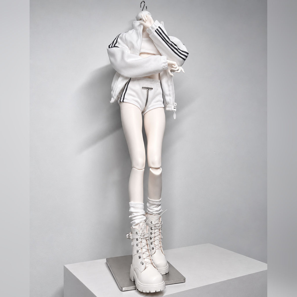 Female BJD body standing pose in white sportswear showing articulated arms and legs