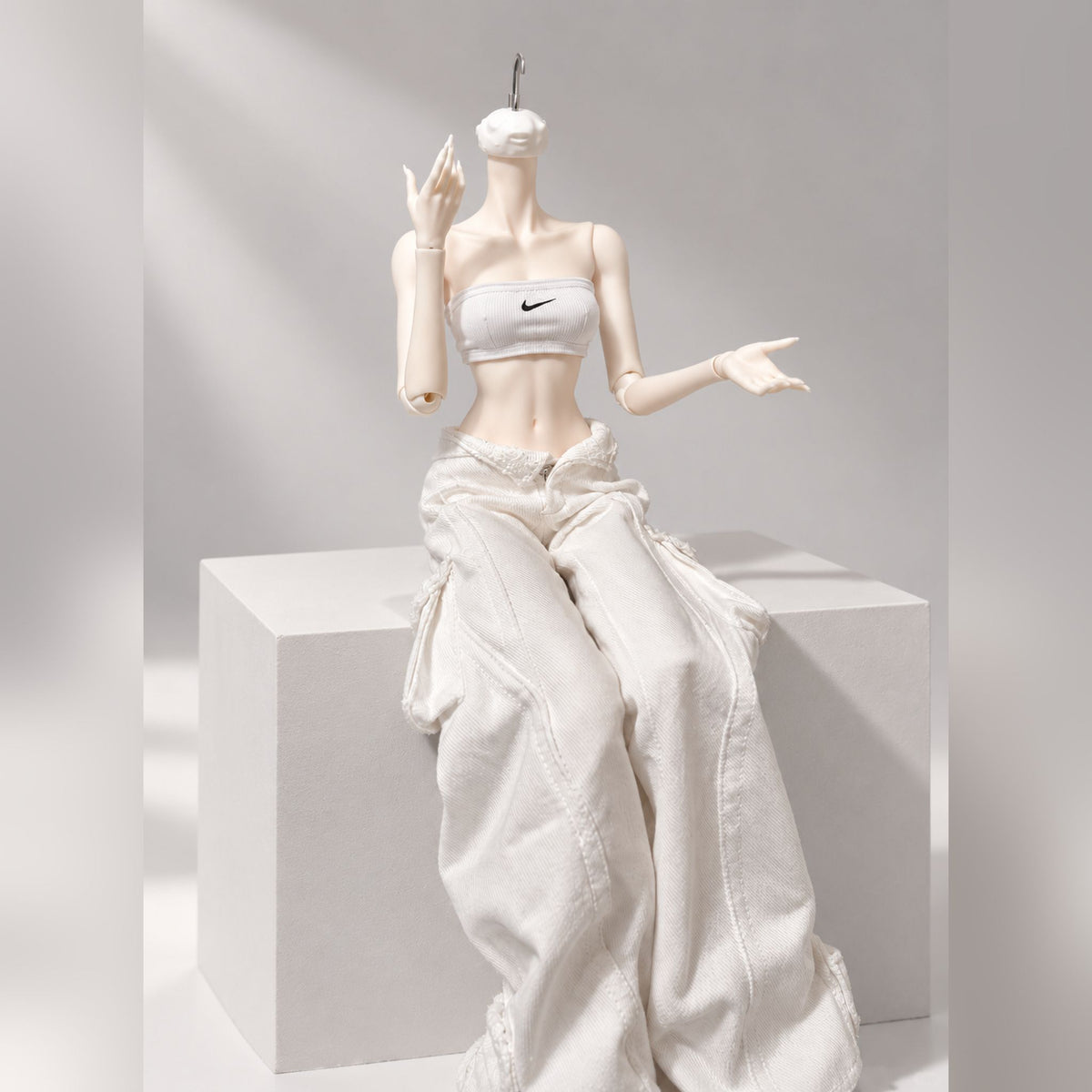 Female BJD body seated pose showing upper body proportions and articulated arms