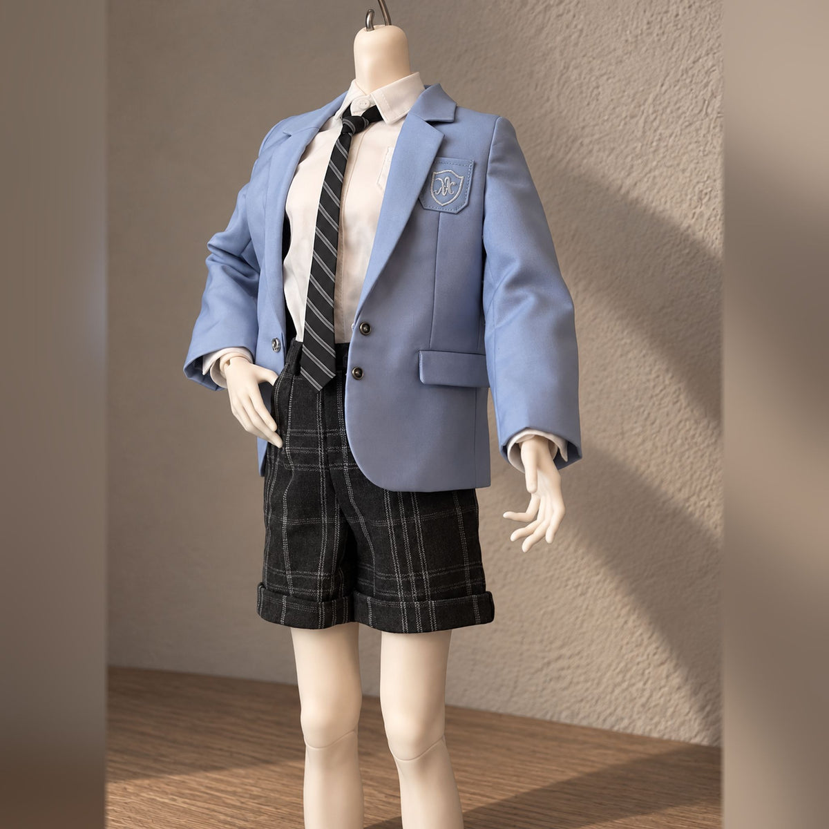 Styled male BJD body wearing a blue school blazer, shirt and plaid shorts