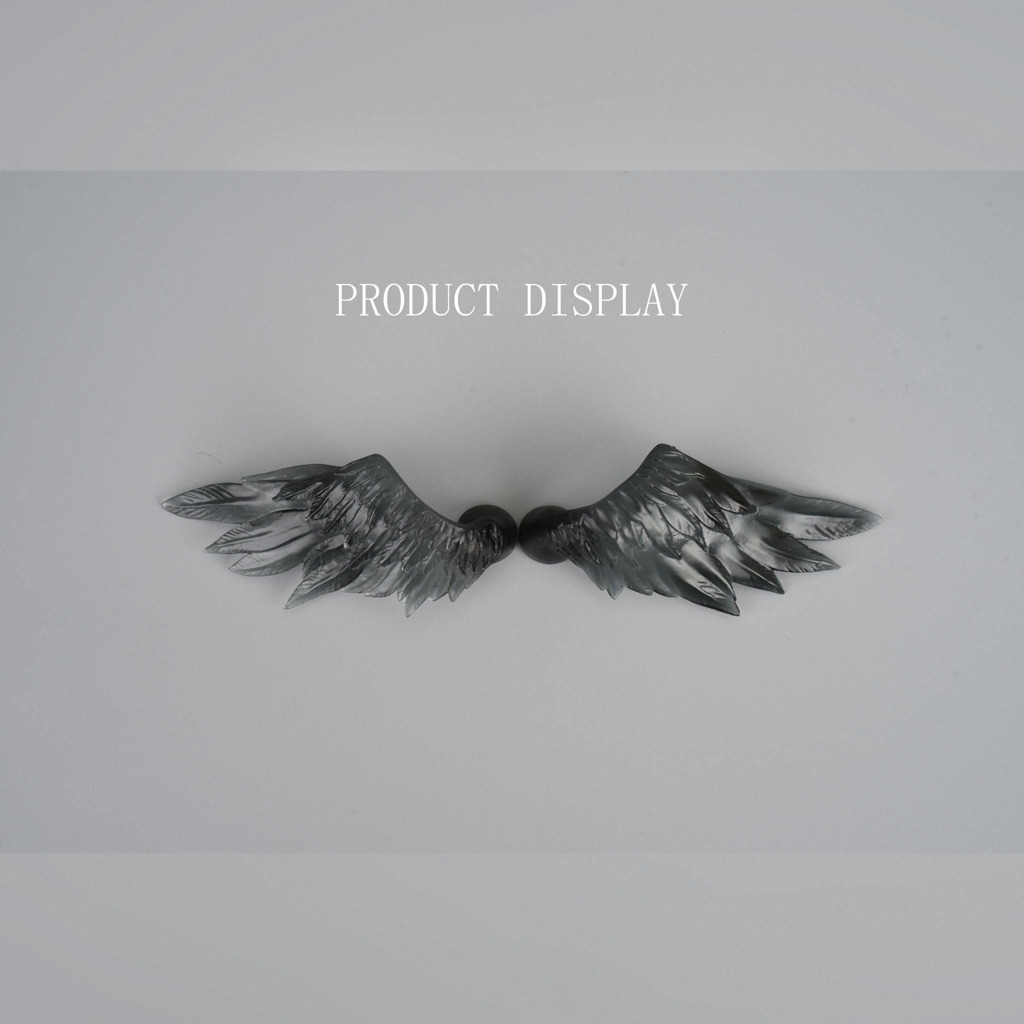 Pair of black feather wings accessory for BJD dolls with realistic sculpted feather texture