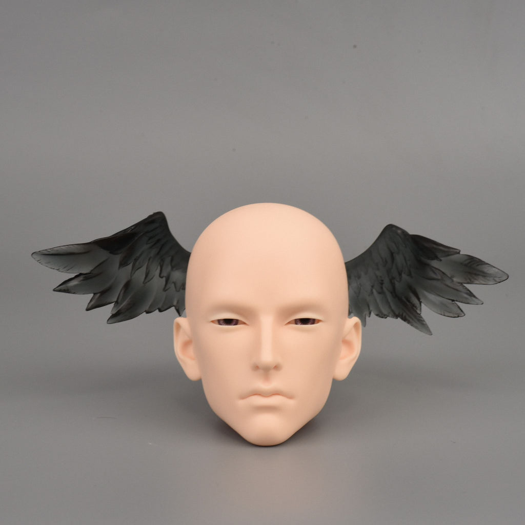 Black BJD doll angel wings accessory attached to resin doll head for fantasy character customization