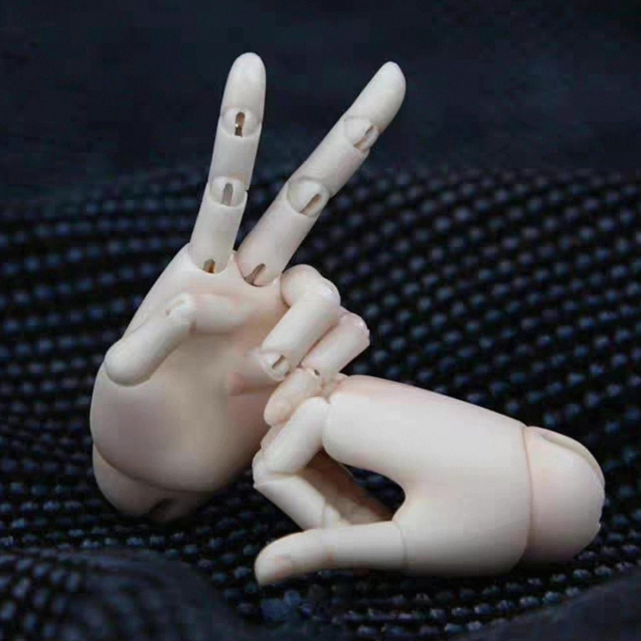 1/4 scale BJD jointed hands showing articulated fingers in a peace sign pose