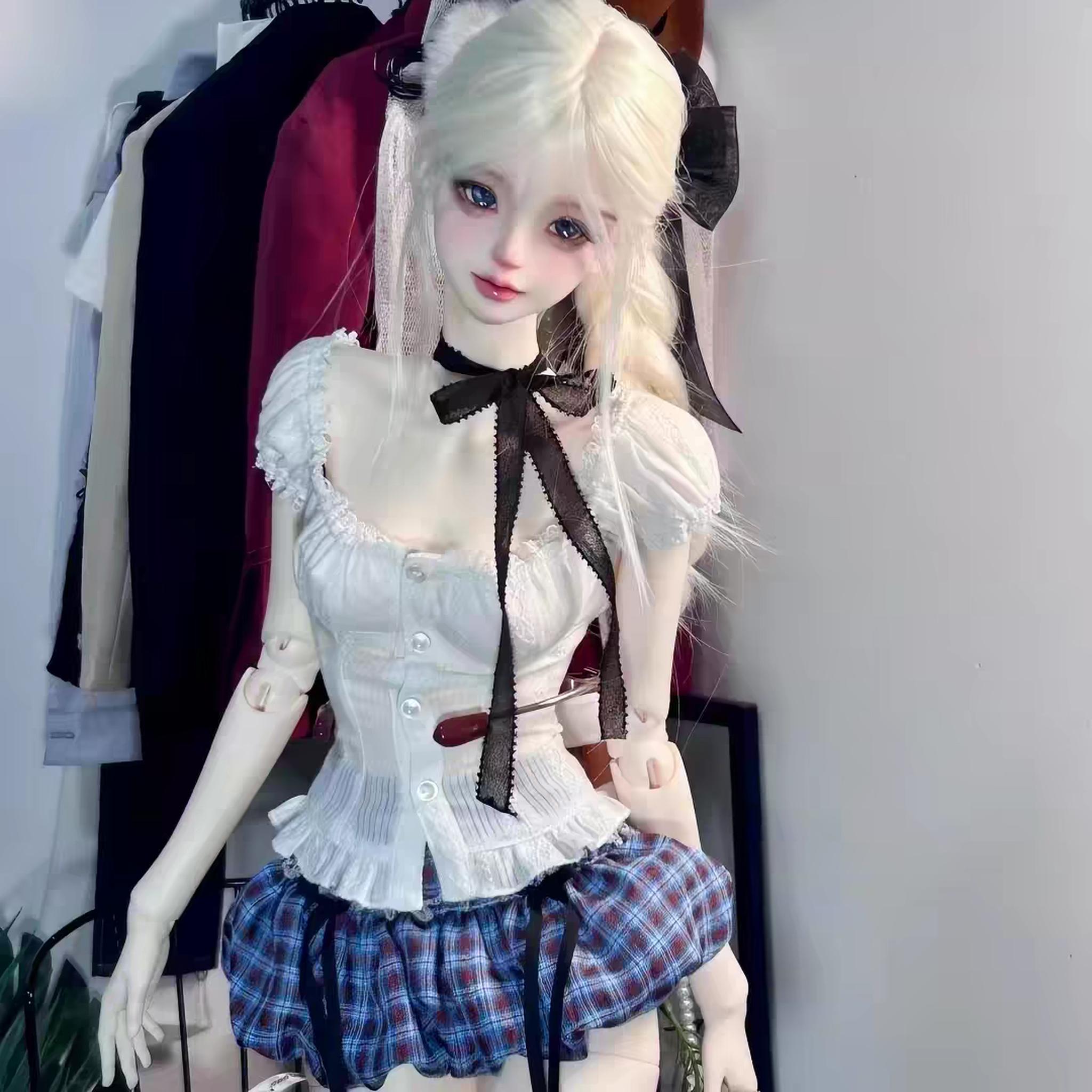 4 scale female BJD body, styled in a white top and plaid skirt